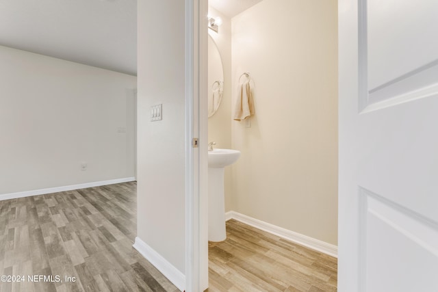 bathroom with hardwood / wood-style floors