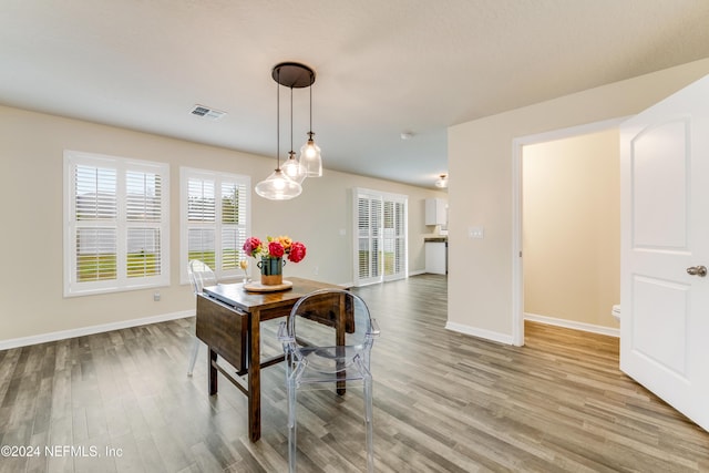 dining area featuring light wood-type flooring