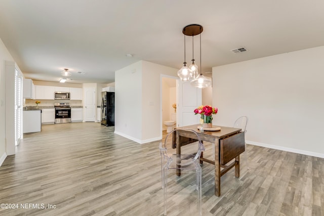 dining room with light hardwood / wood-style floors