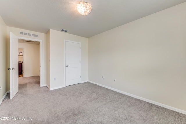 unfurnished bedroom with light carpet