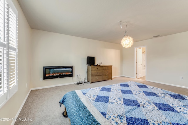 bedroom with carpet floors and connected bathroom