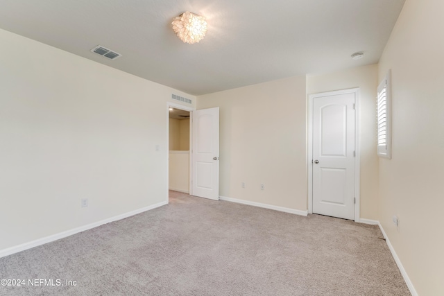 unfurnished bedroom with light colored carpet