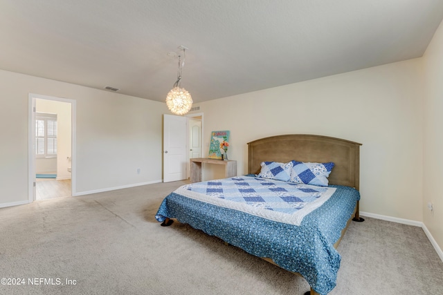 bedroom featuring carpet flooring and ensuite bath