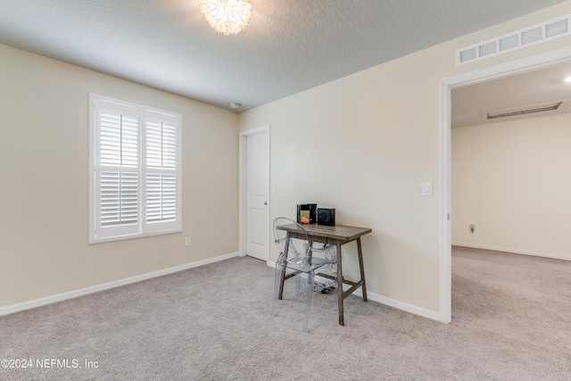 carpeted home office with a textured ceiling