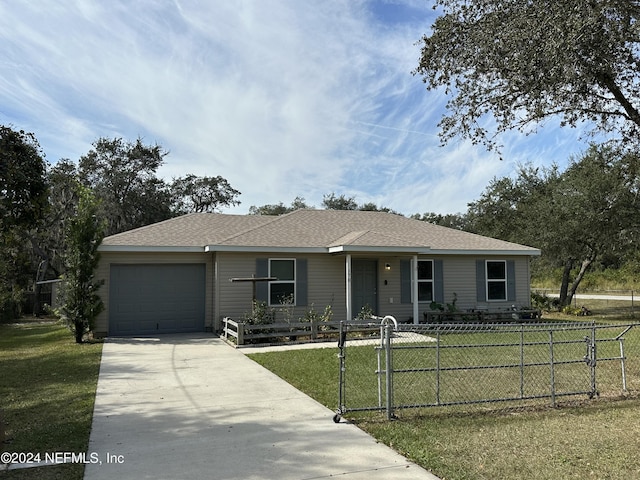 view of front of home featuring a front lawn and a garage