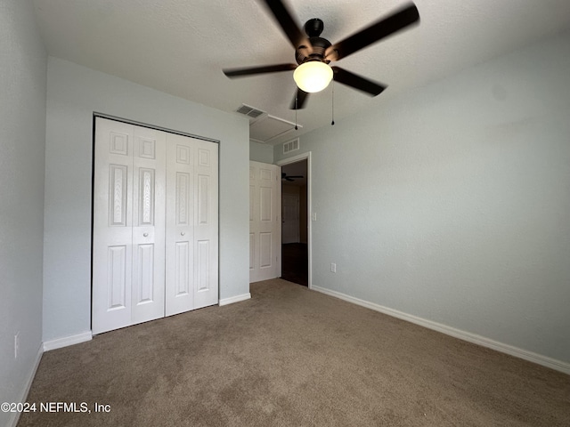 unfurnished bedroom with carpet flooring, ceiling fan, and a closet