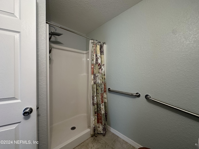 bathroom with a textured ceiling and walk in shower