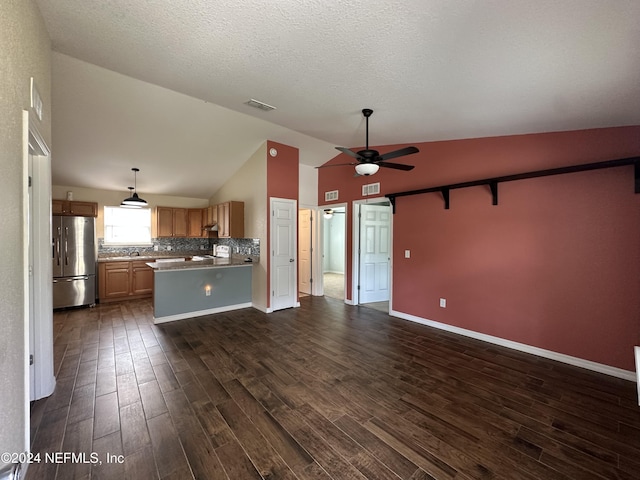 kitchen with pendant lighting, stainless steel fridge, dark hardwood / wood-style flooring, and a textured ceiling