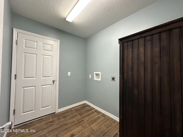 laundry room featuring electric dryer hookup, dark wood-type flooring, a textured ceiling, and washer hookup