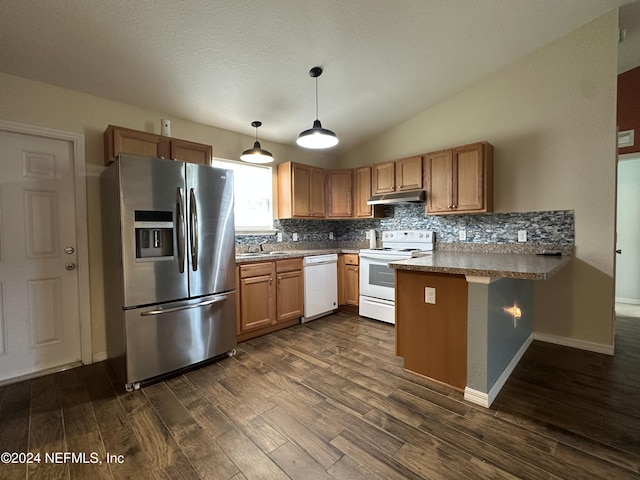 kitchen with kitchen peninsula, dark hardwood / wood-style flooring, white appliances, vaulted ceiling, and hanging light fixtures