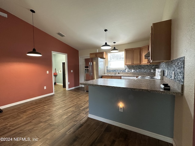 kitchen with dark hardwood / wood-style floors, white appliances, hanging light fixtures, and lofted ceiling