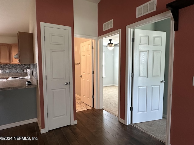 hall with sink and dark wood-type flooring