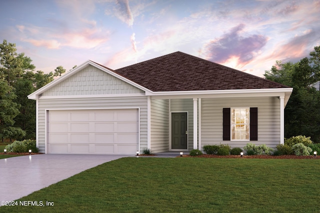 view of front of home with a garage and a lawn