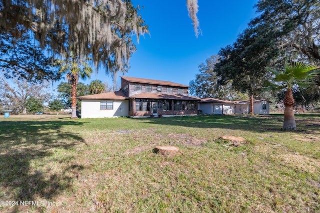 rear view of property with a yard