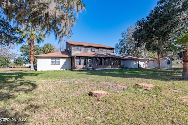 rear view of property featuring a yard