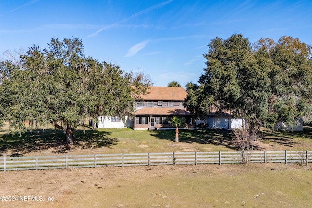 obstructed view of property featuring a rural view and a front yard