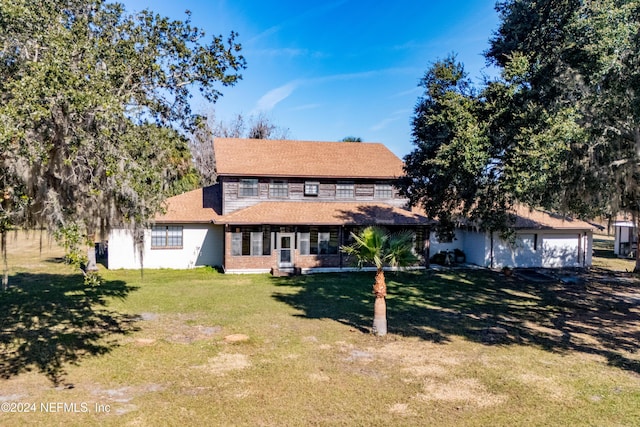 view of front of home with a front lawn and a garage