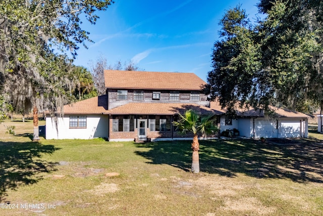 view of front facade with a garage and a front lawn