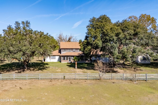 view of property hidden behind natural elements with a rural view