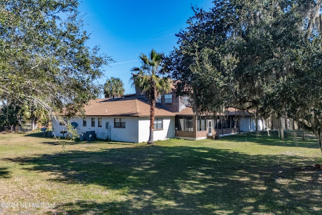 11289 SW 85th Ave, Hampton, FL 32044 - rear view of house with a lawn and a sunroom