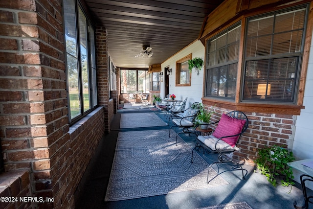 unfurnished sunroom featuring ceiling fan