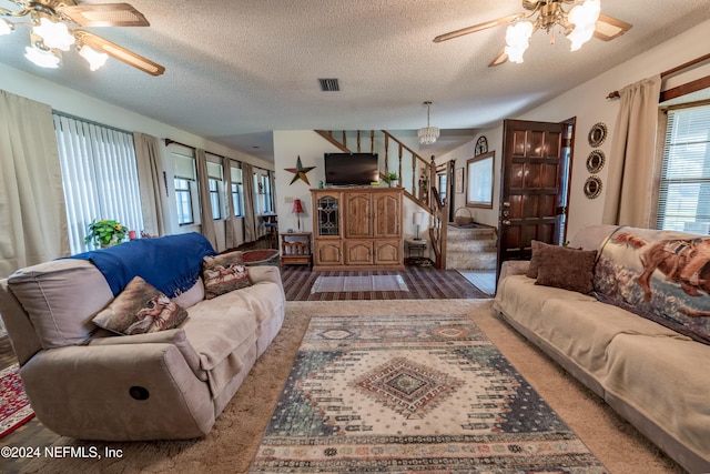 living room featuring ceiling fan, hardwood / wood-style floors, and a textured ceiling