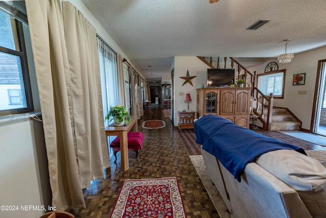 11289 SW 85th Ave, Hampton, FL 32044 - living room with a textured ceiling, stairs, and a chandelier