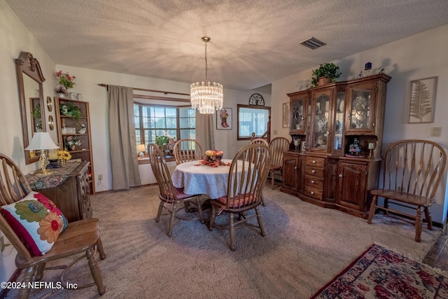 carpeted dining space with a textured ceiling and a chandelier