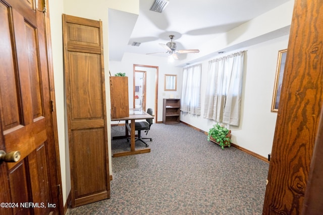 carpeted office space featuring ceiling fan