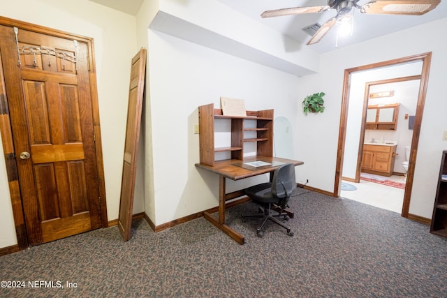 office space featuring ceiling fan and dark carpet