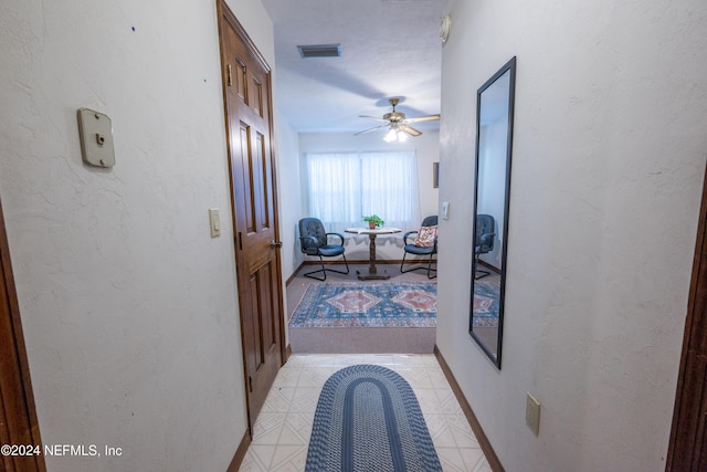 corridor featuring light tile patterned floors