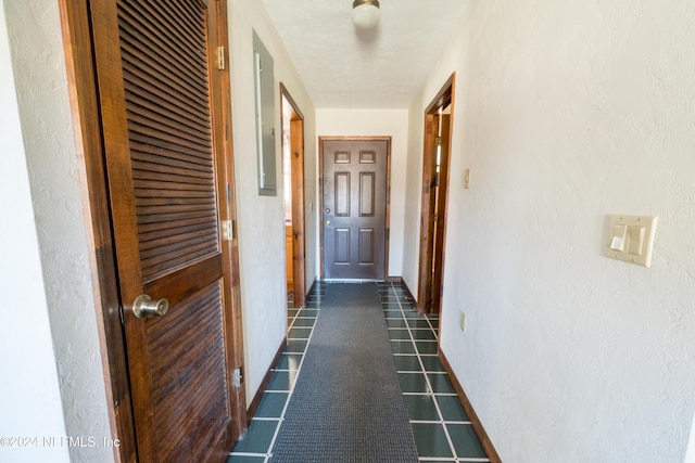 hall featuring dark tile patterned floors