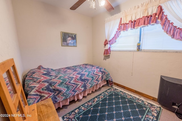 bedroom featuring heating unit, ceiling fan, and carpet floors