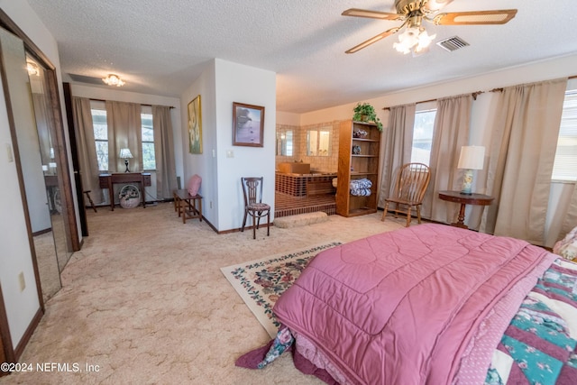 carpeted bedroom with a textured ceiling, a closet, and ceiling fan