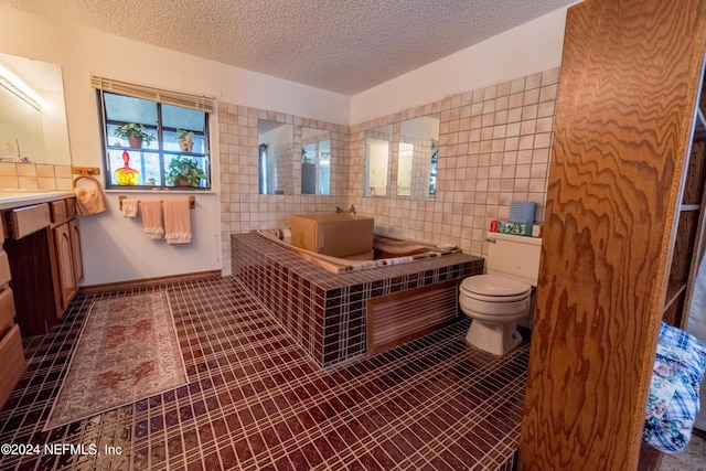 bathroom with tile patterned floors, toilet, tile walls, and a textured ceiling