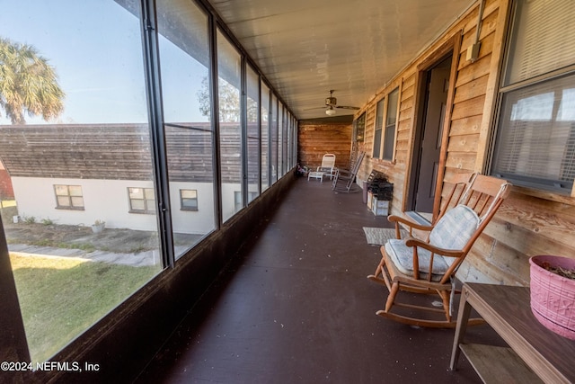 sunroom / solarium featuring ceiling fan