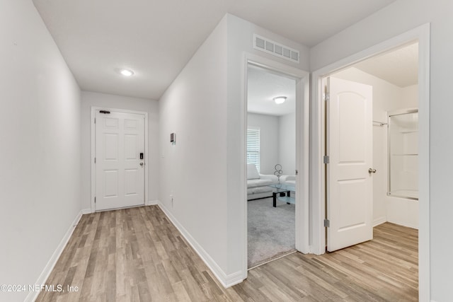 hall with light hardwood / wood-style flooring