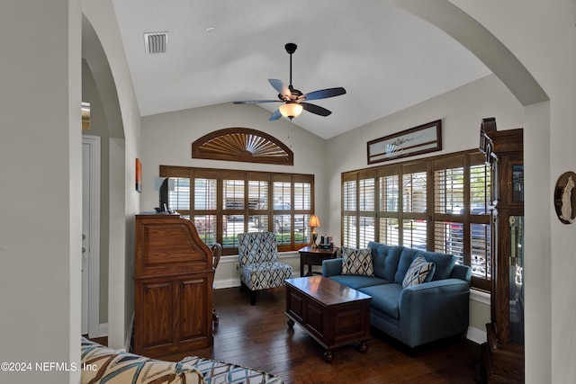 living room featuring dark hardwood / wood-style flooring, vaulted ceiling, and ceiling fan