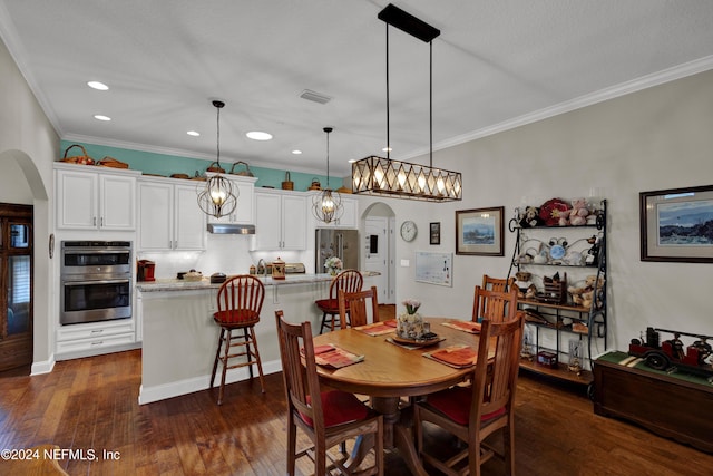 dining area featuring crown molding and dark hardwood / wood-style floors