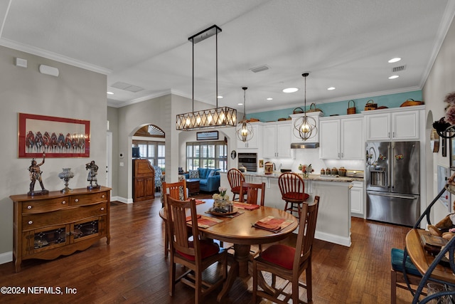 dining space featuring dark hardwood / wood-style floors and crown molding