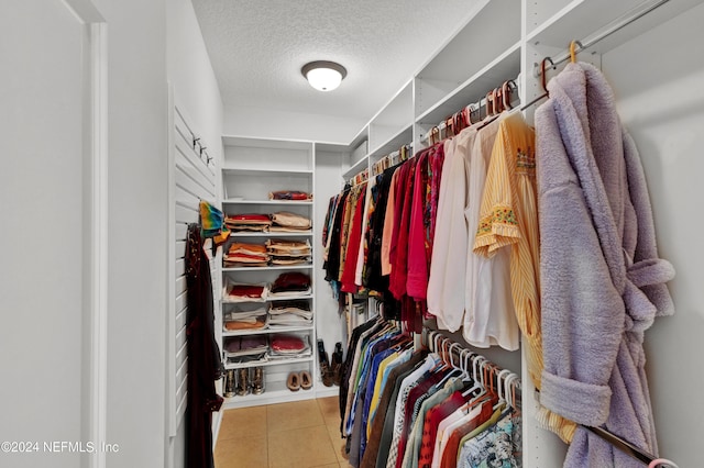 spacious closet featuring light tile patterned flooring