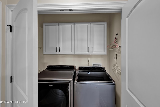 laundry area with cabinets and washing machine and dryer