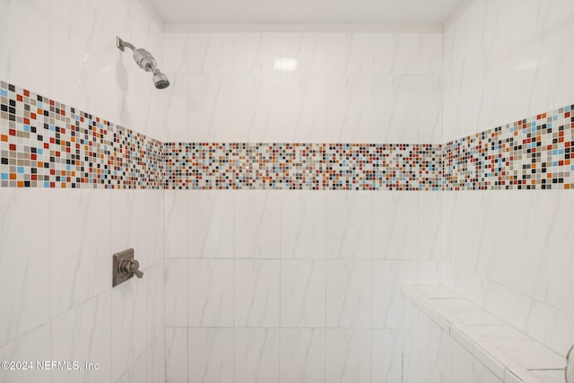 bathroom with tiled shower