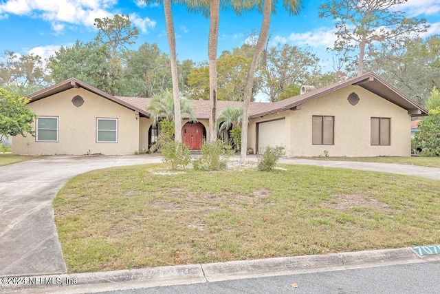 single story home with a front yard and a garage