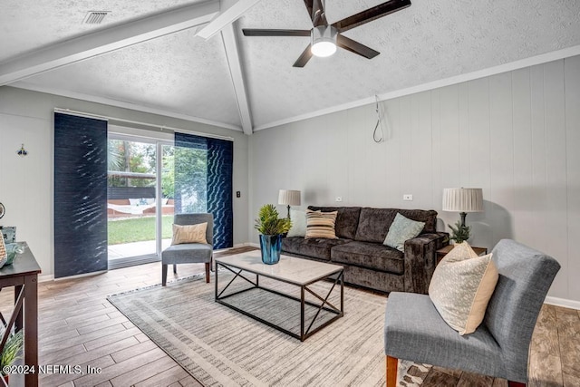 living room featuring vaulted ceiling with beams, ceiling fan, ornamental molding, a textured ceiling, and light hardwood / wood-style floors