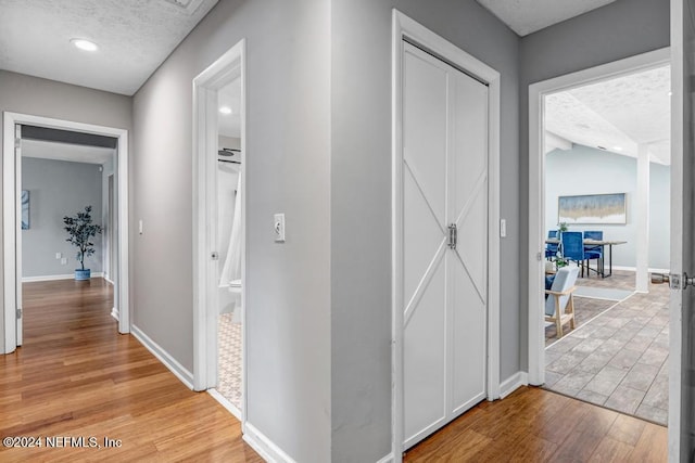 hall with light hardwood / wood-style floors