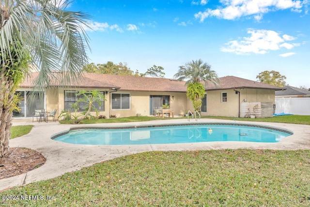 view of swimming pool with a yard and a patio