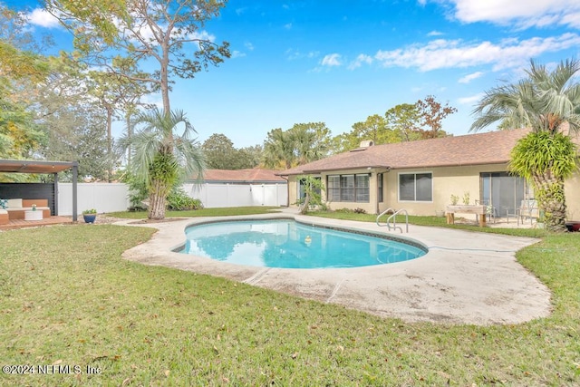 view of pool featuring a yard and a patio