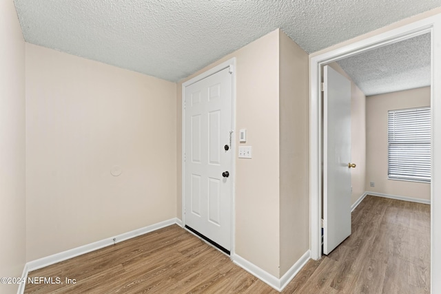 interior space with light hardwood / wood-style floors and a textured ceiling