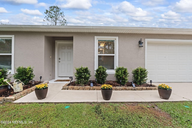 view of exterior entry with a garage